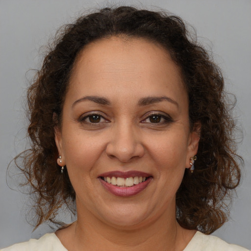 Joyful white adult female with medium  brown hair and brown eyes
