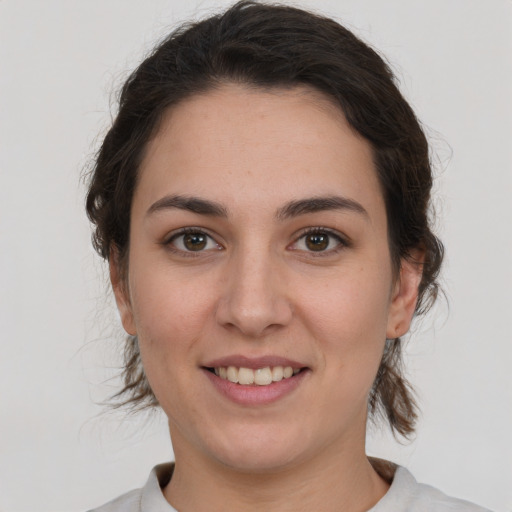 Joyful white young-adult female with medium  brown hair and brown eyes
