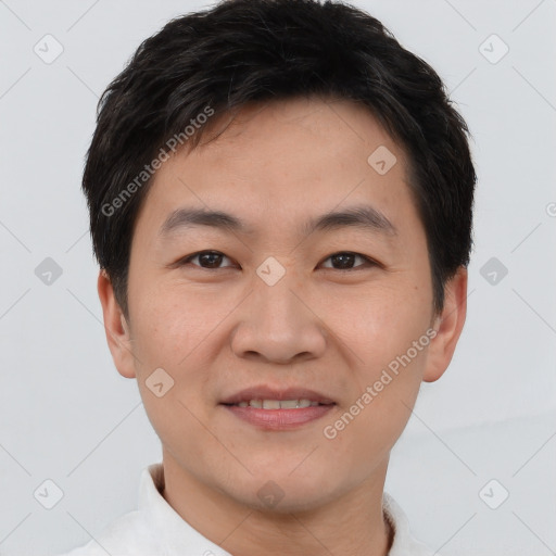 Joyful asian young-adult male with short  brown hair and brown eyes