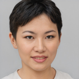 Joyful asian young-adult female with short  brown hair and brown eyes