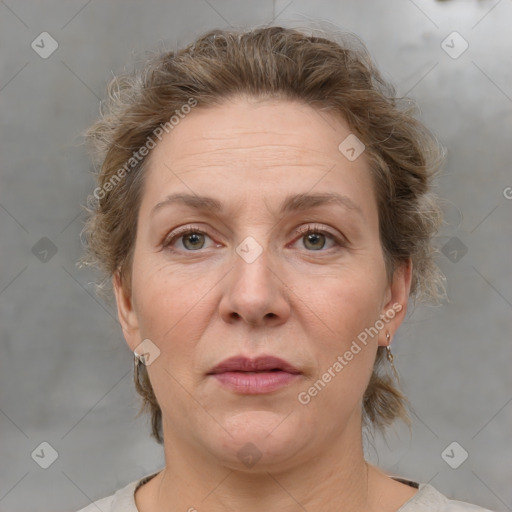 Joyful white adult female with medium  brown hair and grey eyes