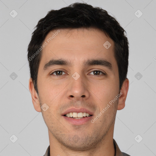 Joyful white young-adult male with short  black hair and brown eyes