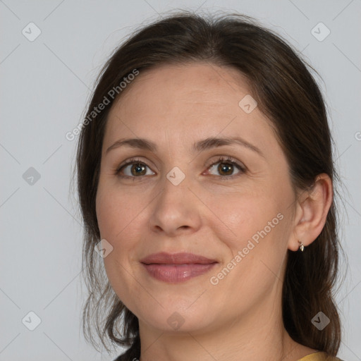 Joyful white adult female with medium  brown hair and brown eyes