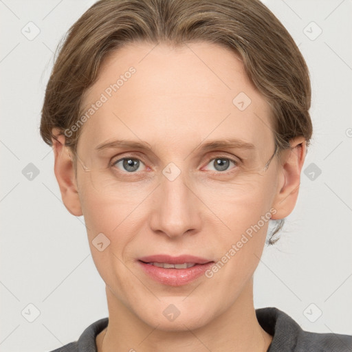 Joyful white adult female with medium  brown hair and grey eyes