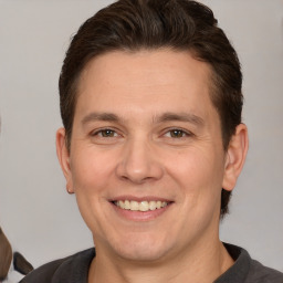 Joyful white adult male with short  brown hair and brown eyes