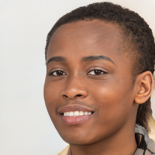 Joyful black young-adult female with long  brown hair and brown eyes