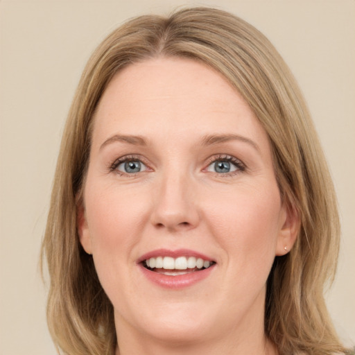 Joyful white young-adult female with medium  brown hair and green eyes