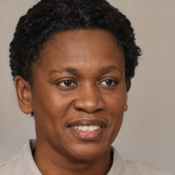 Joyful black adult female with short  brown hair and brown eyes