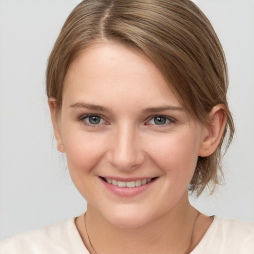 Joyful white young-adult female with medium  brown hair and grey eyes