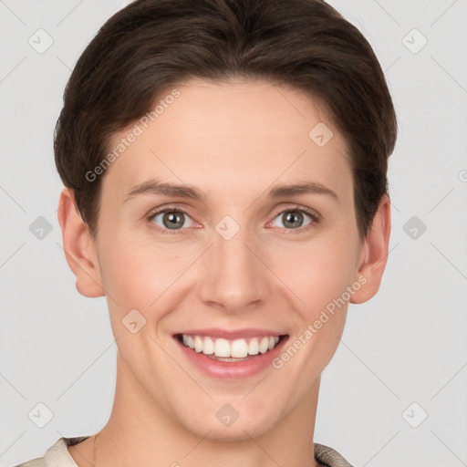 Joyful white young-adult female with short  brown hair and grey eyes