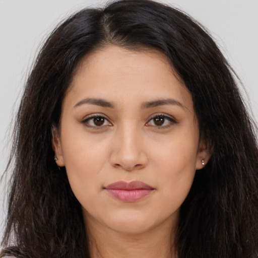 Joyful latino young-adult female with long  brown hair and brown eyes