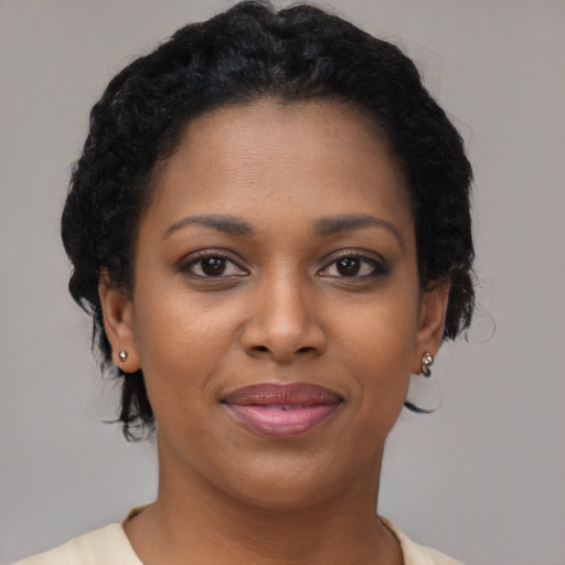 Joyful black young-adult female with short  brown hair and brown eyes