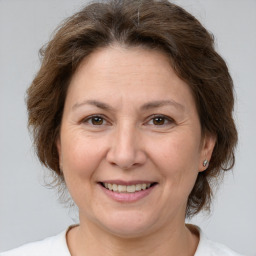 Joyful white adult female with medium  brown hair and brown eyes