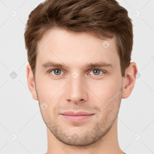 Joyful white young-adult male with short  brown hair and grey eyes