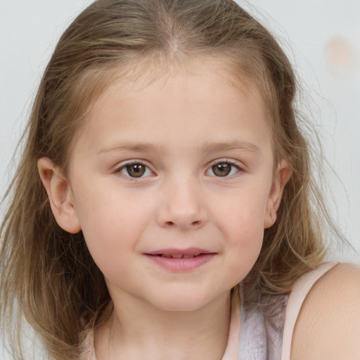 Joyful white child female with medium  brown hair and grey eyes