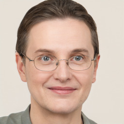 Joyful white adult male with short  brown hair and grey eyes