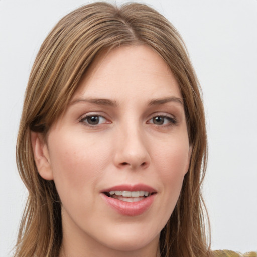 Joyful white young-adult female with long  brown hair and blue eyes