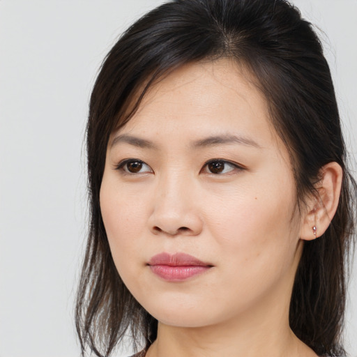 Joyful asian young-adult female with long  brown hair and brown eyes