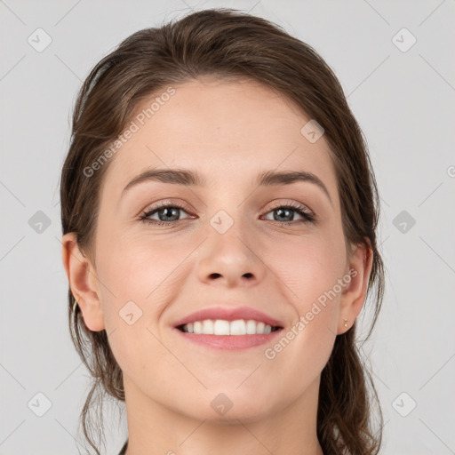 Joyful white young-adult female with medium  brown hair and grey eyes