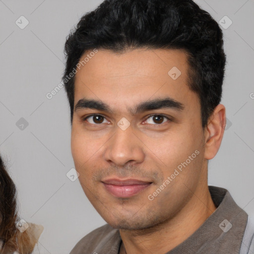 Joyful latino young-adult male with short  black hair and brown eyes