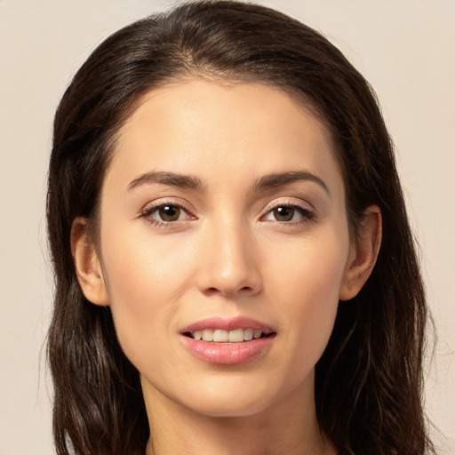 Joyful white young-adult female with long  brown hair and brown eyes