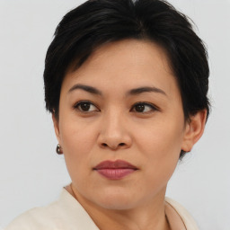 Joyful asian young-adult female with short  brown hair and brown eyes