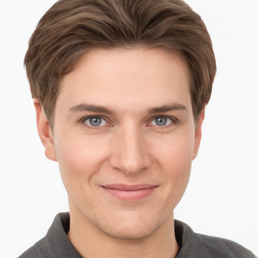 Joyful white young-adult male with short  brown hair and grey eyes