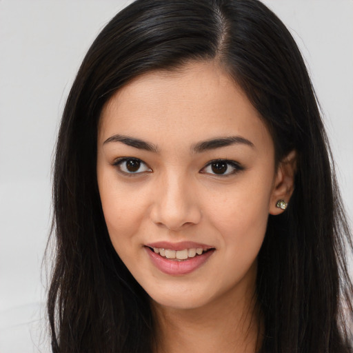 Joyful asian young-adult female with long  brown hair and brown eyes