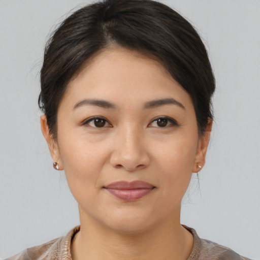 Joyful asian young-adult female with medium  brown hair and brown eyes