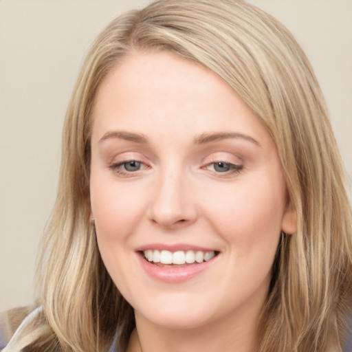 Joyful white young-adult female with long  brown hair and blue eyes