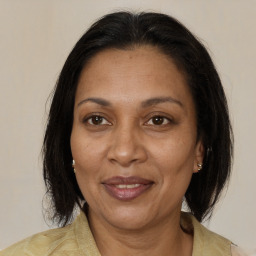 Joyful black adult female with medium  brown hair and brown eyes