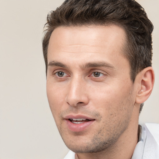 Joyful white young-adult male with short  brown hair and brown eyes