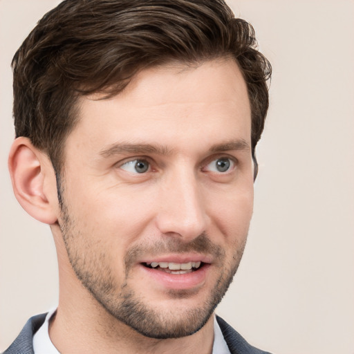 Joyful white young-adult male with short  brown hair and grey eyes