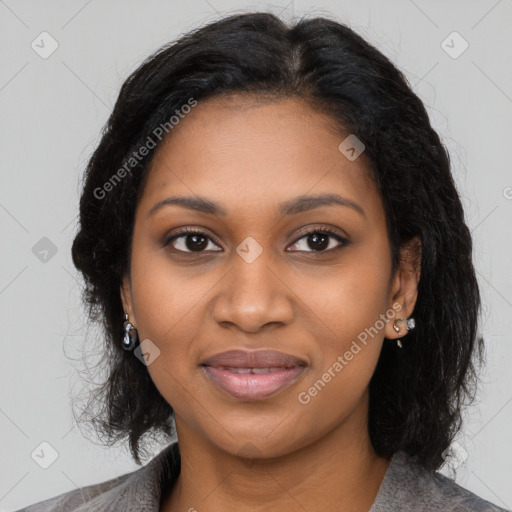 Joyful black young-adult female with long  black hair and brown eyes