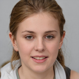 Joyful white young-adult female with medium  brown hair and blue eyes