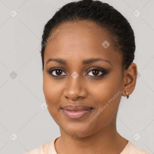 Joyful black young-adult female with short  brown hair and brown eyes