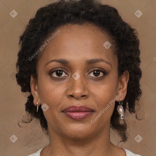 Joyful black adult female with medium  brown hair and brown eyes