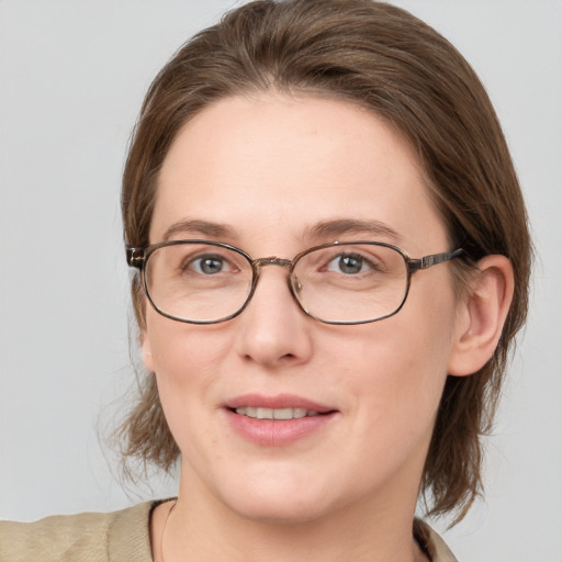 Joyful white young-adult female with medium  brown hair and blue eyes