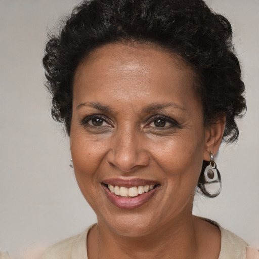 Joyful black adult female with short  brown hair and brown eyes