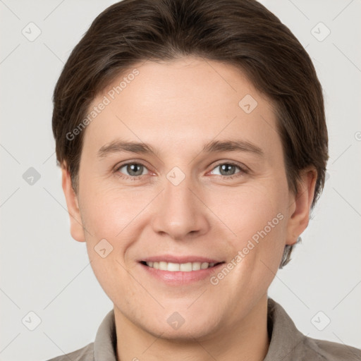 Joyful white young-adult female with short  brown hair and grey eyes