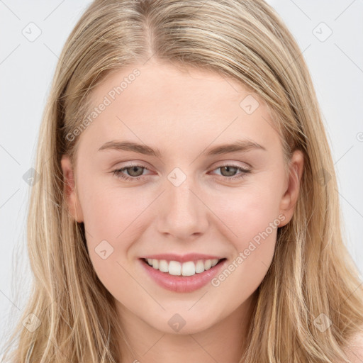 Joyful white young-adult female with long  brown hair and blue eyes