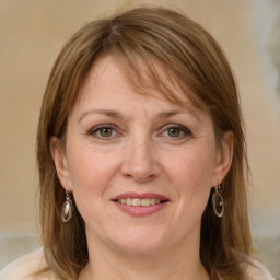 Joyful white adult female with medium  brown hair and grey eyes