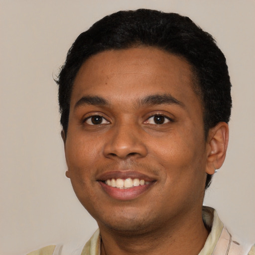 Joyful black young-adult male with short  black hair and brown eyes