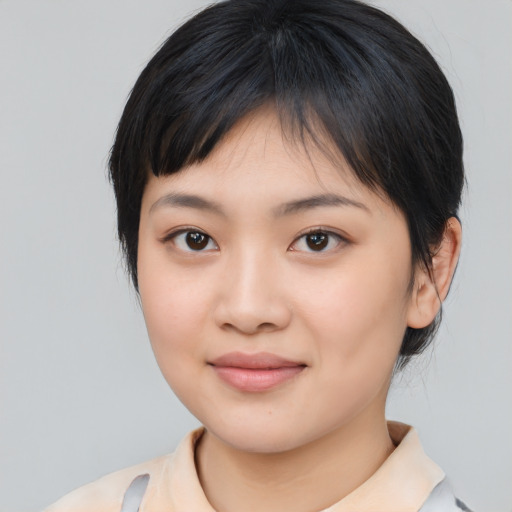 Joyful asian young-adult female with medium  black hair and brown eyes