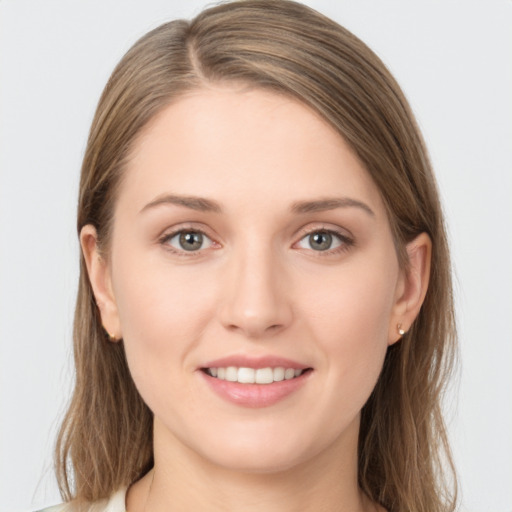 Joyful white young-adult female with long  brown hair and grey eyes