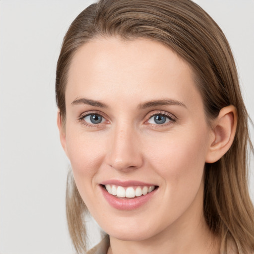 Joyful white young-adult female with long  brown hair and grey eyes