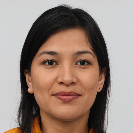 Joyful latino young-adult female with long  brown hair and brown eyes