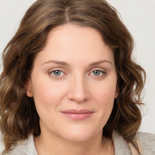 Joyful white young-adult female with medium  brown hair and green eyes