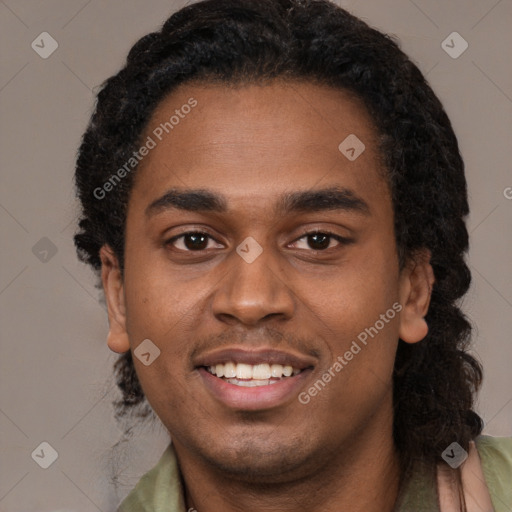 Joyful black young-adult male with short  black hair and brown eyes