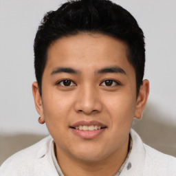 Joyful asian young-adult male with short  black hair and brown eyes